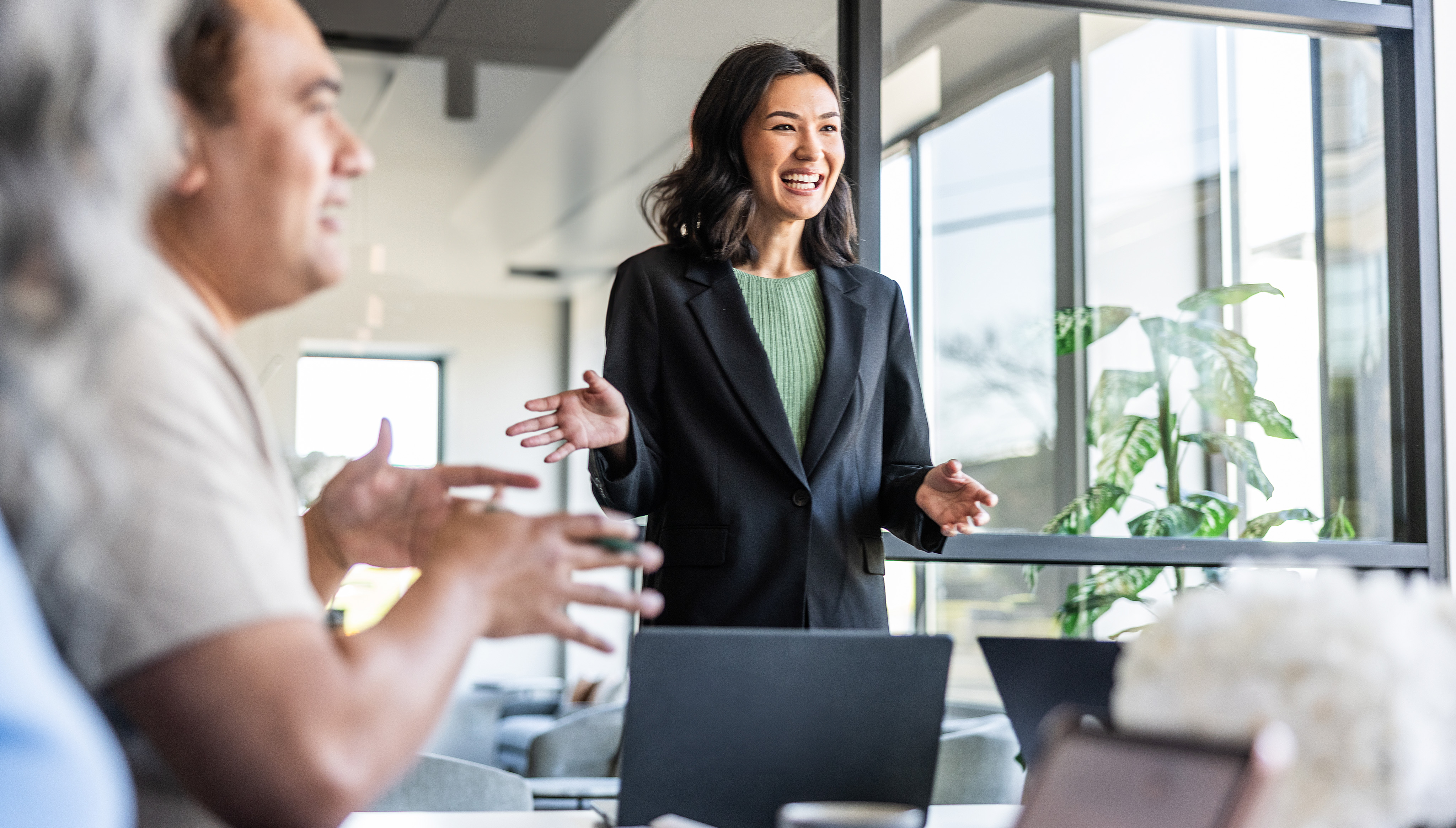 A woman presents to a conference room